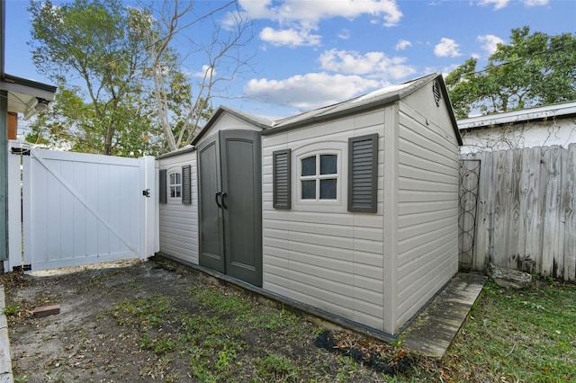 view of shed with a gate and fence