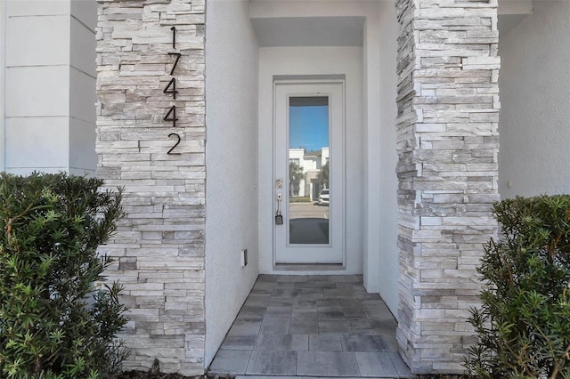17442 Hidden Forest Dr, Clermont, FL 34714 - doorway to property with stone siding