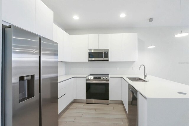 17442 Hidden Forest Dr, Clermont, FL 34714 - kitchen featuring appliances with stainless steel finishes, a sink, a peninsula, light countertops, and recessed lighting