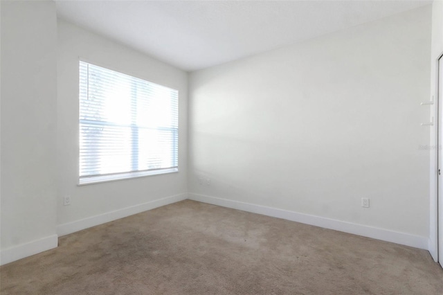 17442 Hidden Forest Dr, Clermont, FL 34714 - empty room featuring healthy amount of natural light, carpet flooring, and baseboards