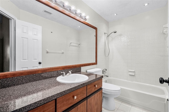 bathroom with toilet, vanity, visible vents, tub / shower combination, and tile patterned floors