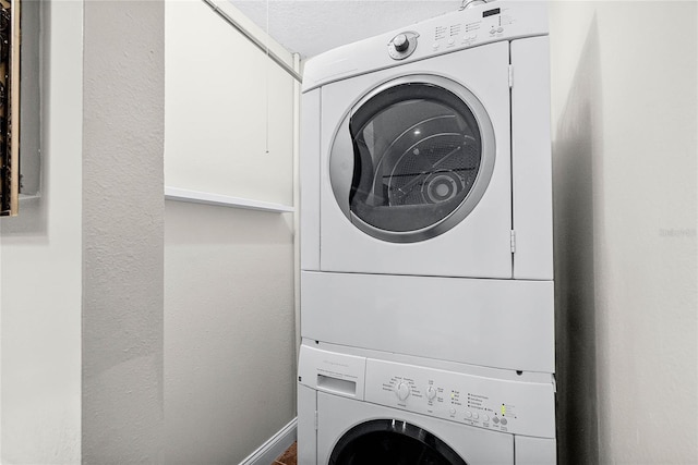 laundry room featuring stacked washer and clothes dryer