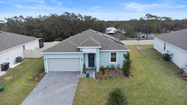 ranch-style home with driveway, a garage, a fenced backyard, central AC, and a front yard