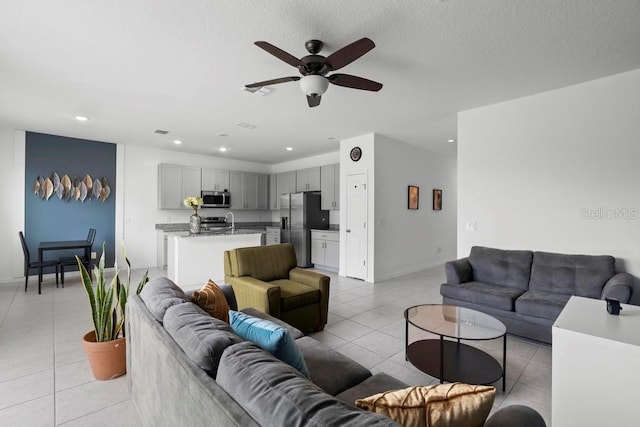 living room featuring visible vents, a ceiling fan, light tile patterned flooring, a textured ceiling, and recessed lighting