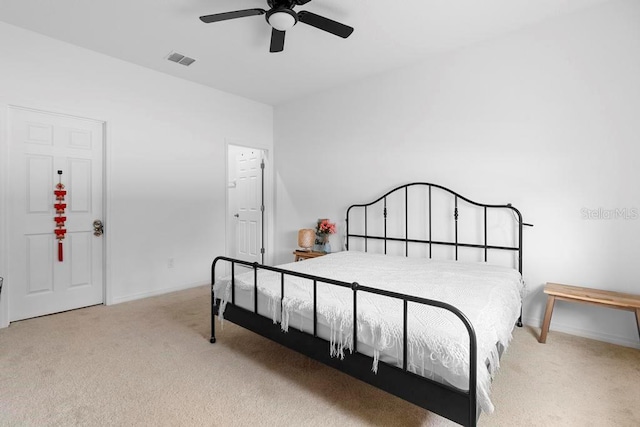 carpeted bedroom with ceiling fan, visible vents, and baseboards