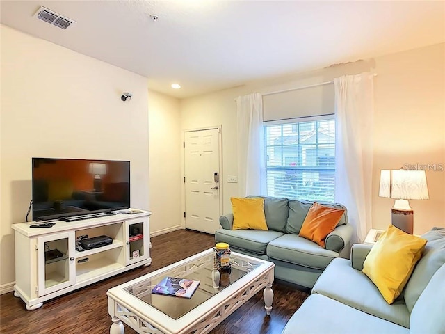 living area with dark wood-style floors, recessed lighting, visible vents, and baseboards