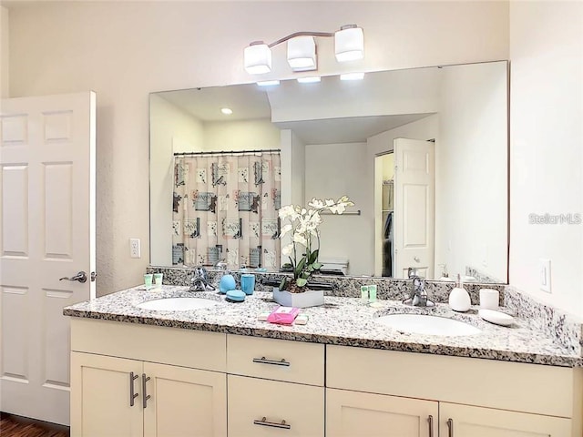 full bath with double vanity and a sink