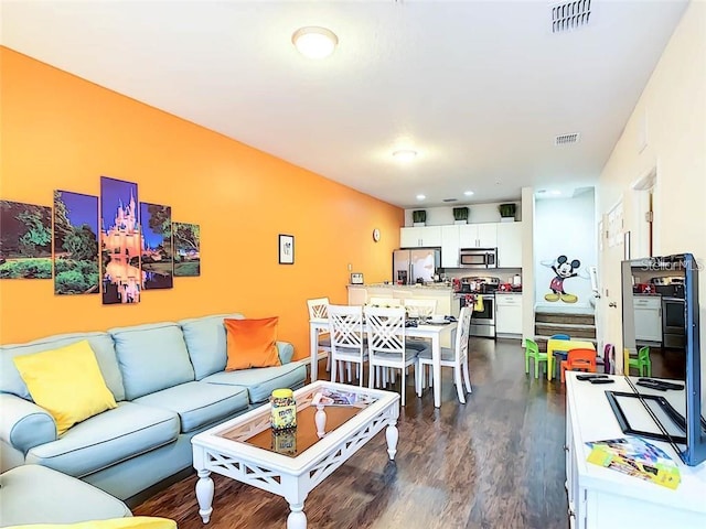 living area featuring dark wood-style floors and visible vents