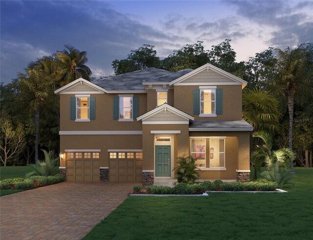 view of front of house featuring a yard, stucco siding, a garage, stone siding, and decorative driveway