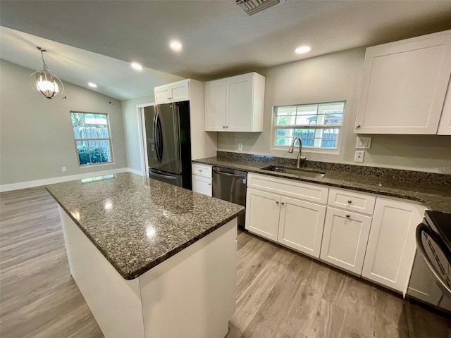 kitchen with visible vents, white cabinets, a sink, refrigerator with ice dispenser, and dishwasher