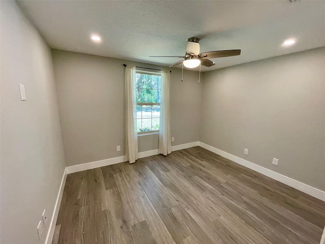 unfurnished room with a ceiling fan, baseboards, wood finished floors, and recessed lighting