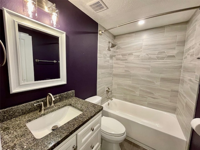 bathroom featuring a textured ceiling, toilet, vanity, visible vents, and washtub / shower combination