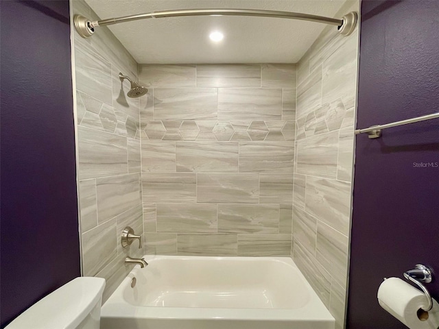 full bathroom with washtub / shower combination and toilet