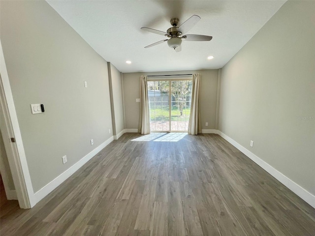 unfurnished room featuring ceiling fan, baseboards, and wood finished floors