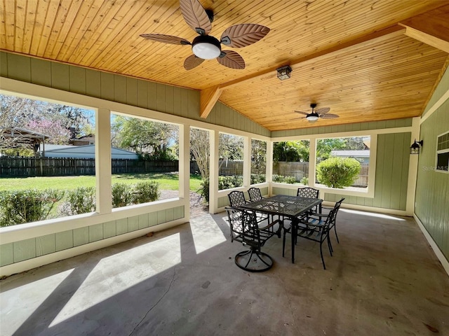 sunroom with lofted ceiling, wood ceiling, and a ceiling fan