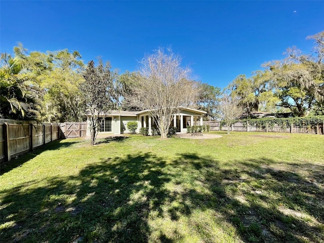 view of yard with a patio area and a fenced backyard