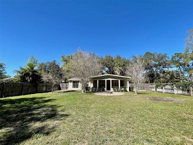 rear view of property with a patio area, a fenced backyard, and a yard