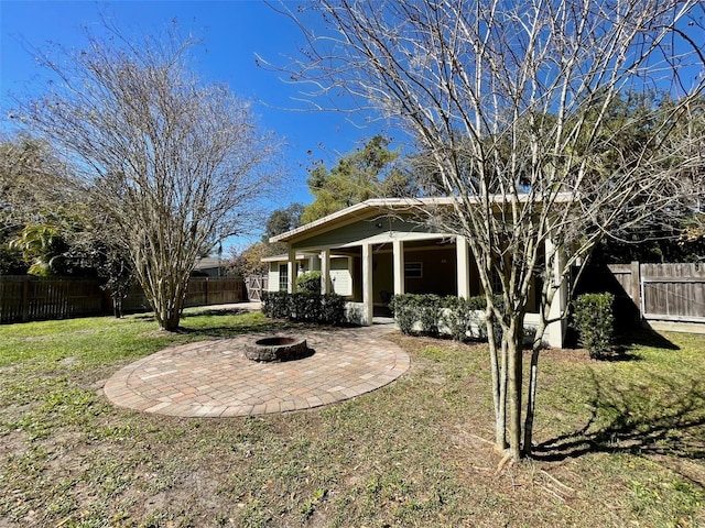 view of yard with a fenced backyard, a patio, and a fire pit