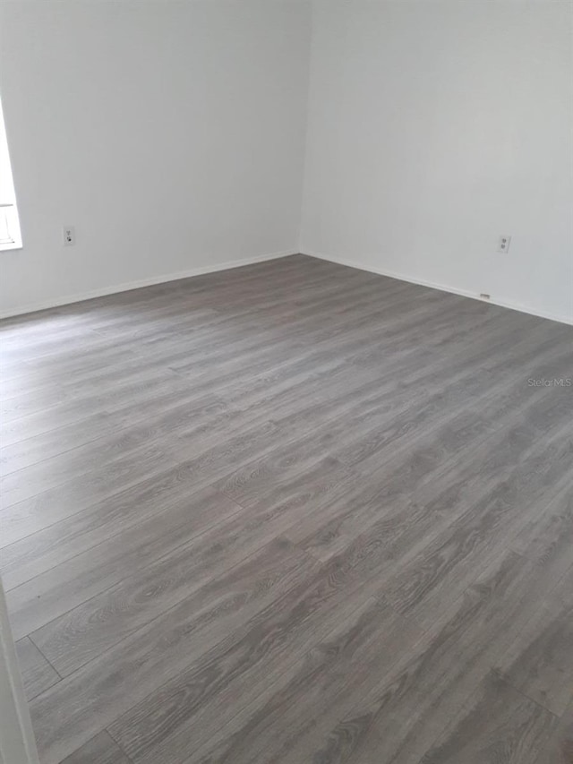 spare room with dark wood-type flooring