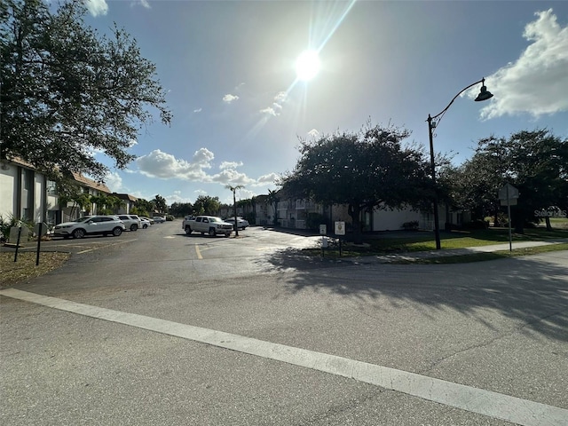 view of road featuring street lights and sidewalks