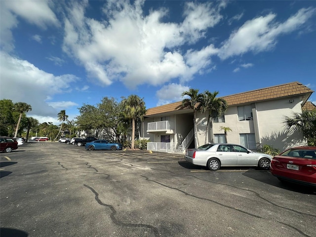 view of building exterior featuring uncovered parking