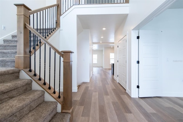 entrance foyer with stairway, recessed lighting, wood finished floors, and baseboards