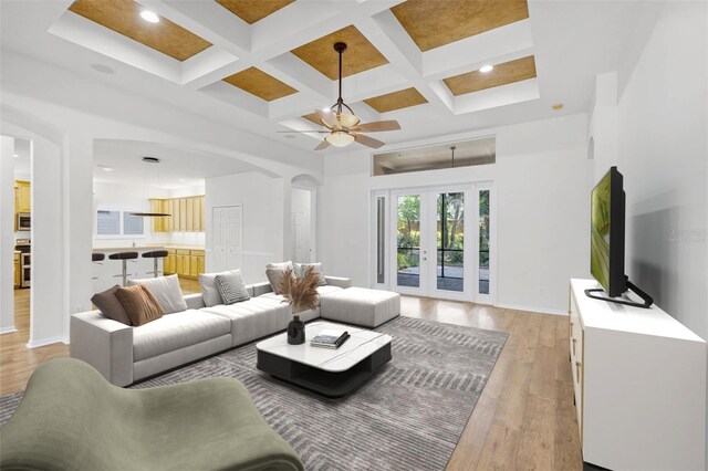 1203 Gatwick Loop, Lake Mary, FL 32746 - living area with arched walkways, light wood-type flooring, a ceiling fan, coffered ceiling, and beamed ceiling