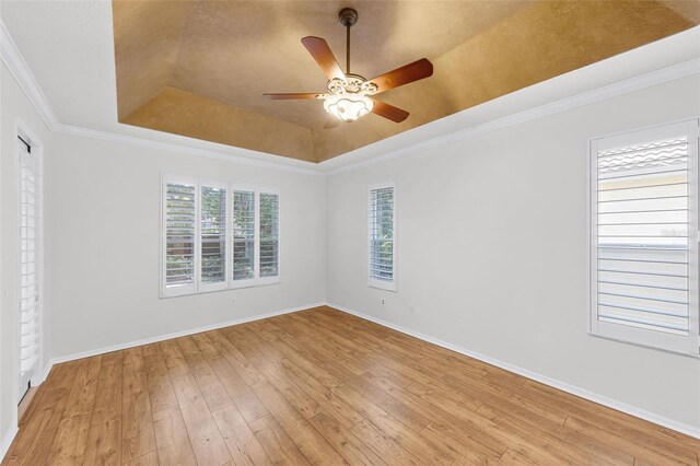 1203 Gatwick Loop, Lake Mary, FL 32746 - spare room with a tray ceiling, ceiling fan, light wood-style floors, baseboards, and crown molding