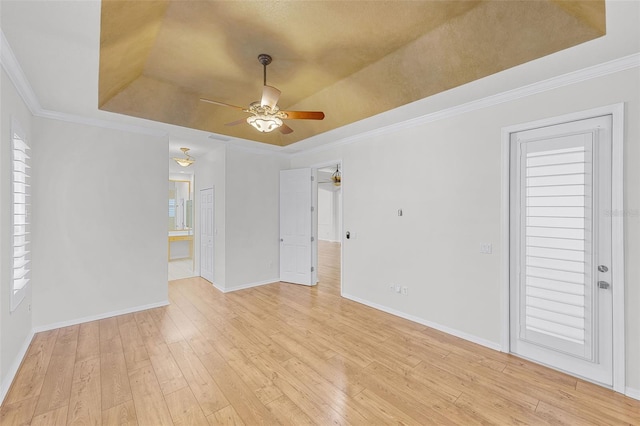 1203 Gatwick Loop, Lake Mary, FL 32746 - spare room with a raised ceiling, ceiling fan, light wood-style floors, baseboards, and ornamental molding