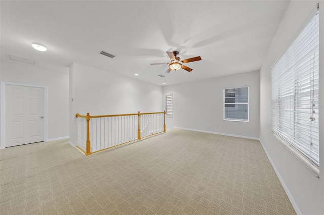 1203 Gatwick Loop, Lake Mary, FL 32746 - spare room with a ceiling fan, light colored carpet, healthy amount of natural light, and baseboards