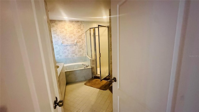 full bath featuring a shower stall, tile patterned floors, a garden tub, and wallpapered walls