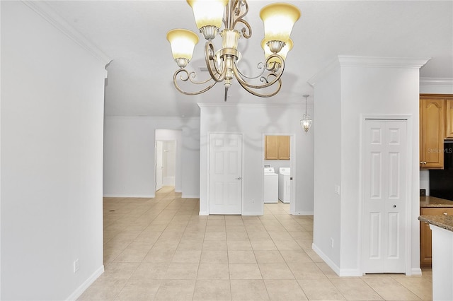 unfurnished dining area with light tile patterned flooring, separate washer and dryer, baseboards, an inviting chandelier, and crown molding