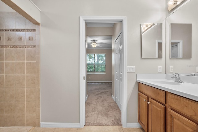 bathroom with ceiling fan, vanity, baseboards, tile patterned floors, and crown molding