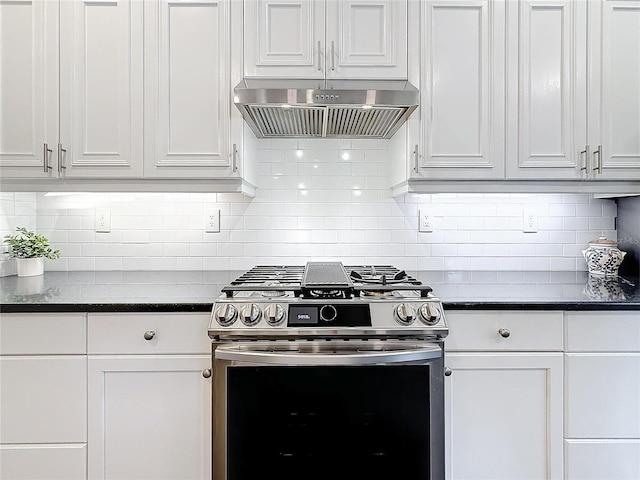 kitchen with dark countertops, range hood, white cabinetry, and gas stove