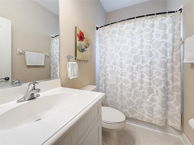 bathroom with tile patterned flooring, vanity, and toilet