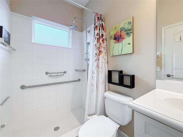 full bathroom featuring toilet, a tile shower, and vanity