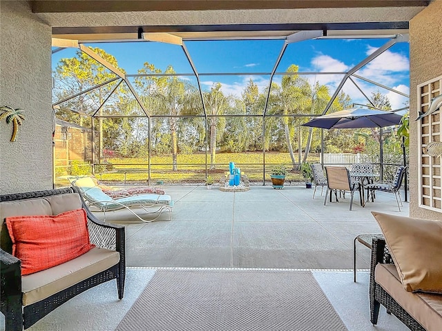 view of patio / terrace featuring outdoor dining space and a lanai