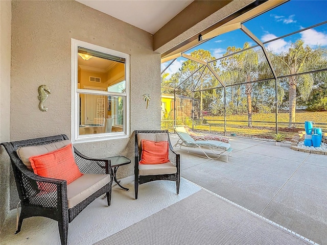 view of patio featuring a lanai and visible vents