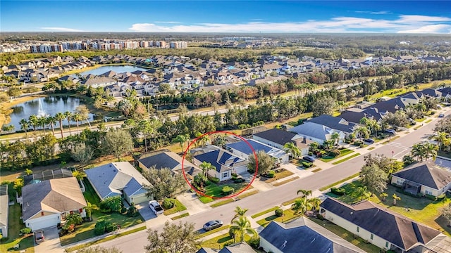 bird's eye view featuring a water view and a residential view