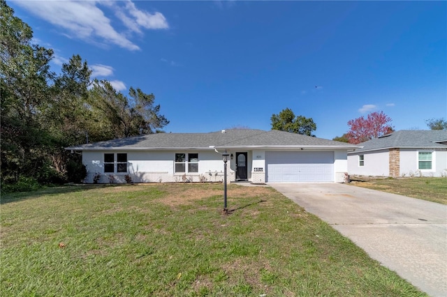 ranch-style house with an attached garage, driveway, a front yard, and stucco siding