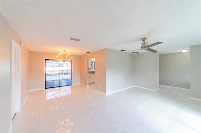 spare room with a textured ceiling, ceiling fan with notable chandelier, visible vents, baseboards, and marble finish floor