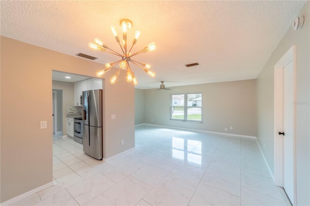 empty room featuring marble finish floor, visible vents, and ceiling fan with notable chandelier