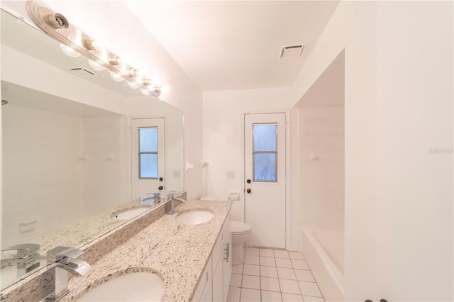 bathroom featuring visible vents, a sink, and tile patterned floors