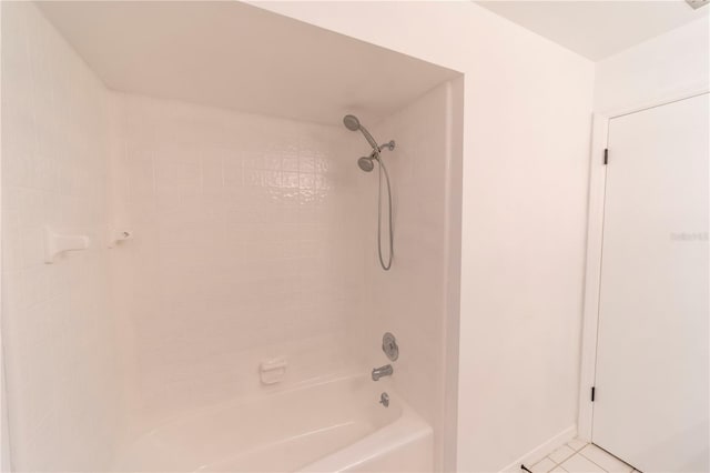 bathroom featuring baseboards, bathing tub / shower combination, and tile patterned floors