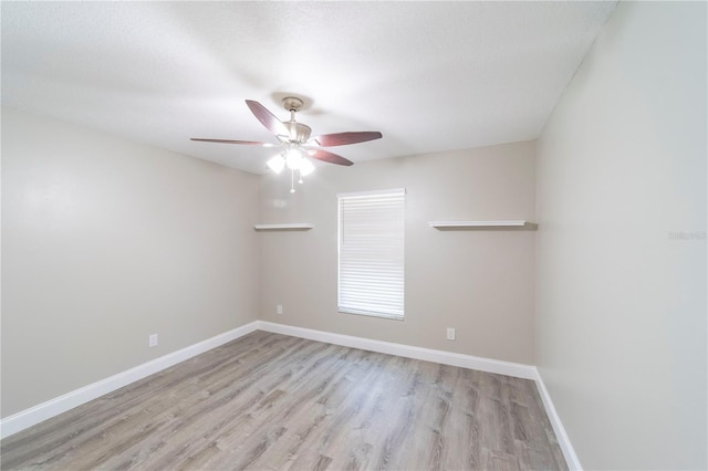 empty room featuring light wood-type flooring, ceiling fan, and baseboards