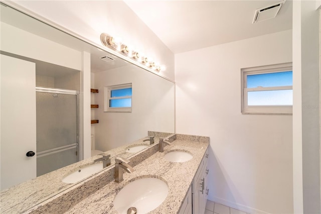 bathroom featuring visible vents and a sink