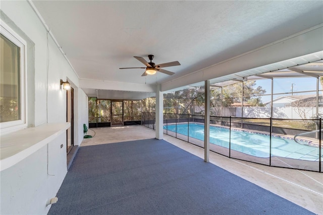 unfurnished sunroom featuring a ceiling fan