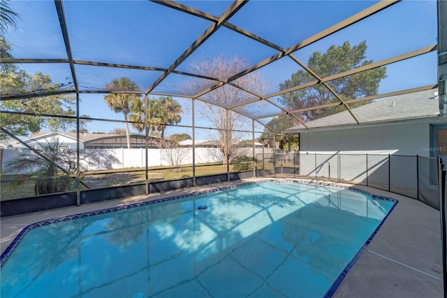 view of swimming pool featuring a patio area, a lanai, a fenced in pool, and fence