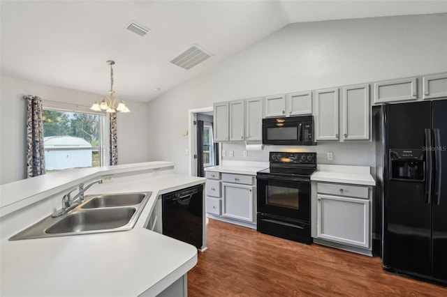 kitchen with visible vents, light countertops, gray cabinetry, black appliances, and a sink