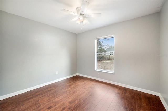 spare room featuring ceiling fan, baseboards, and wood finished floors